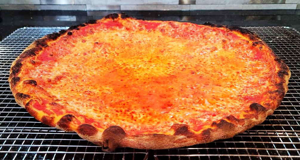 Charred New Haven apizza on a wire rack